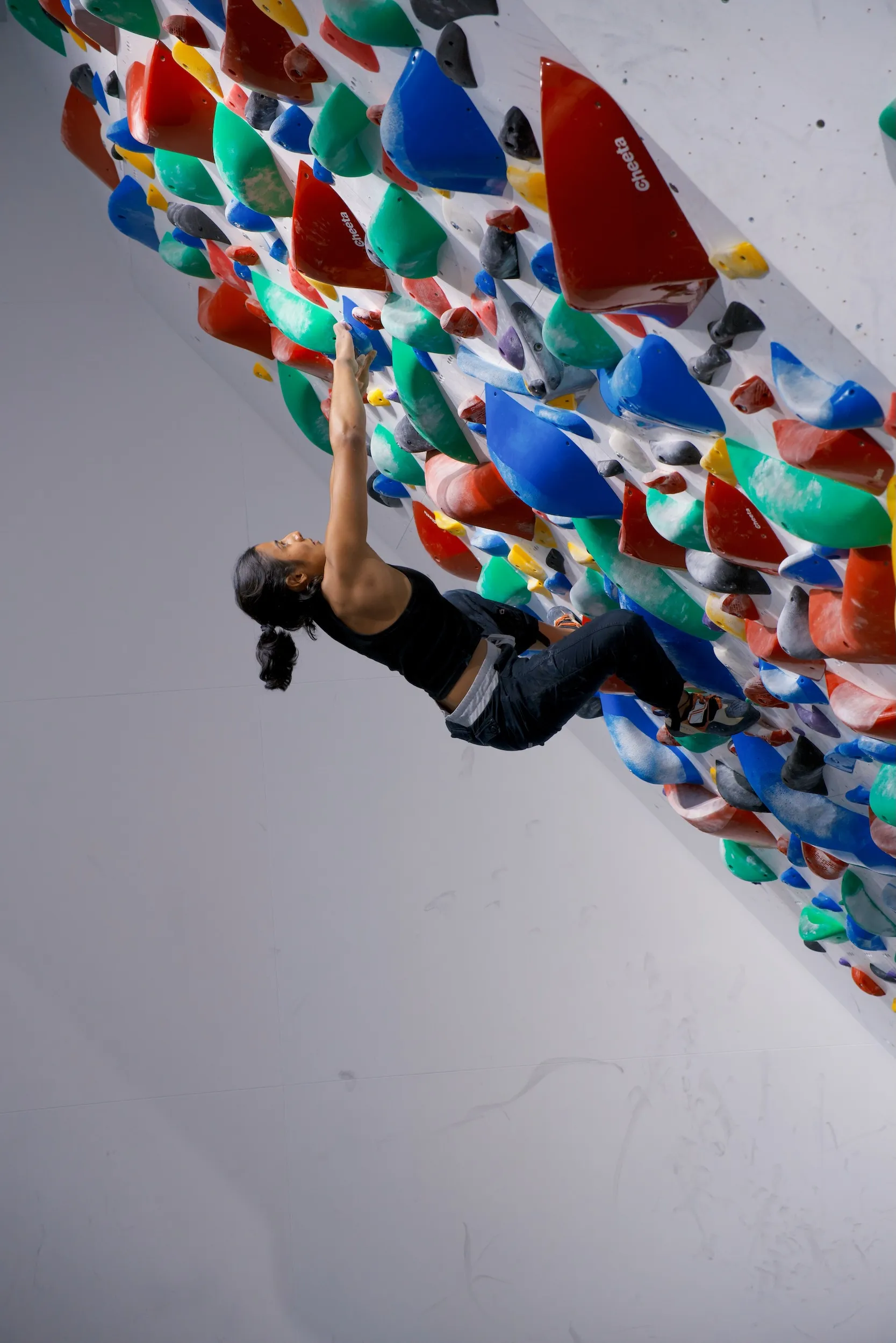 Coach working with athlete on overhang